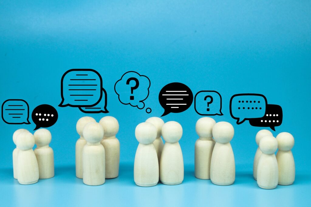 peg doll with message notification icon, chat social media interaction.