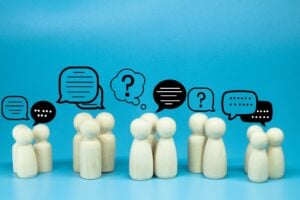 peg doll with message notification icon, chat social media interaction.